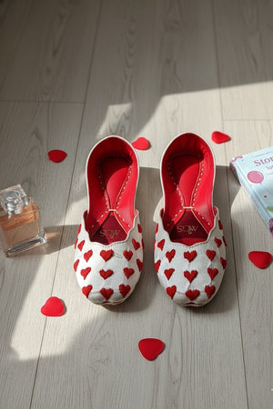 White khussa flats with red hand-embroidered heart motifs