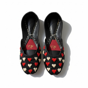Close-up of heart embroidery on black velvet Punjabi jutti