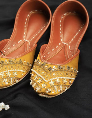 Mustard Punjabi jutti for women with pearl embellishments