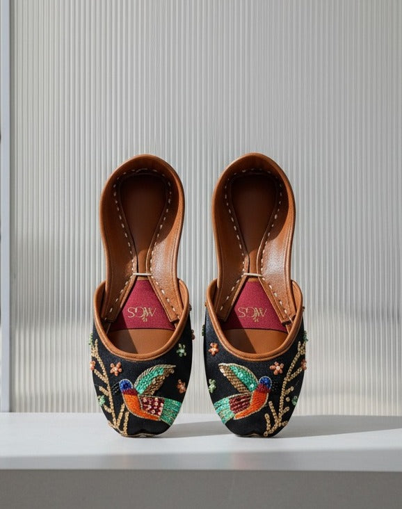 Black embroidered Punjabi jutti for women with colorful bird motif