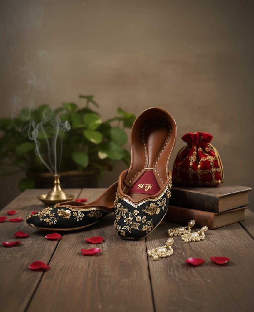 Close-up of black gold jutti with sequins and floral patterns