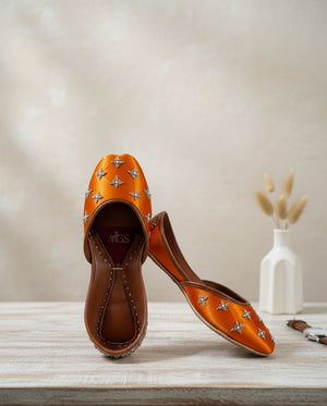Orange satin khussa flats with silver floral details